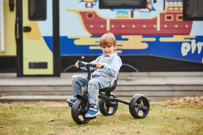 Child Learning how to ride a tricycle